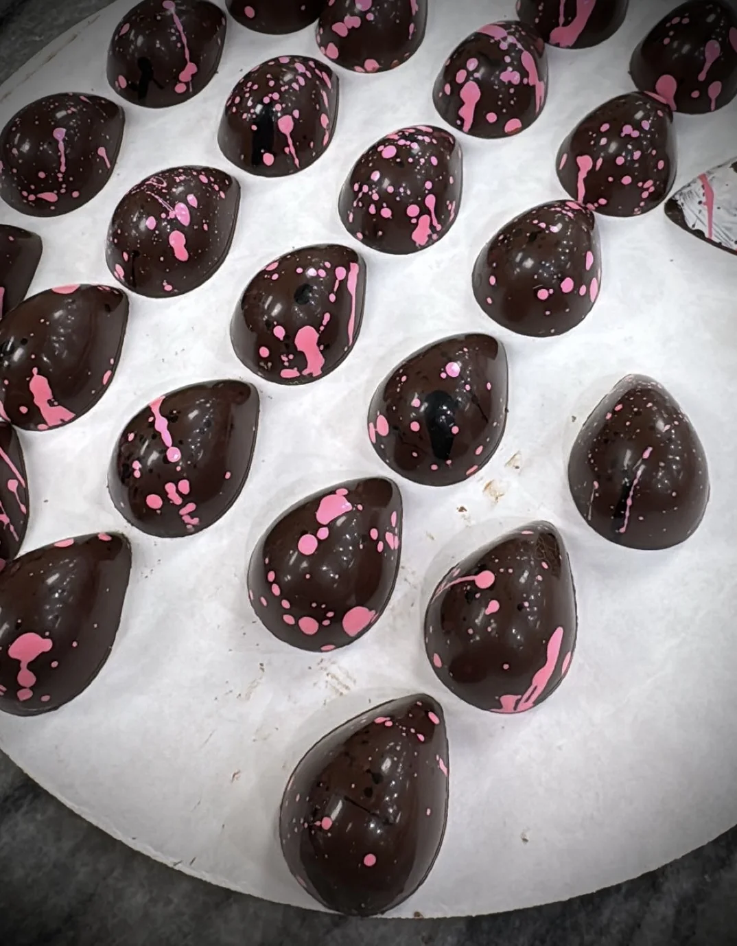 Œuf Praliné — rose-splattered dark chocolate bonbons with hazelnut praliné and fleur de sel